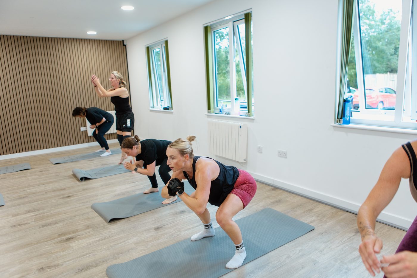 A client working through a personalised kettlebell training plan with Jess